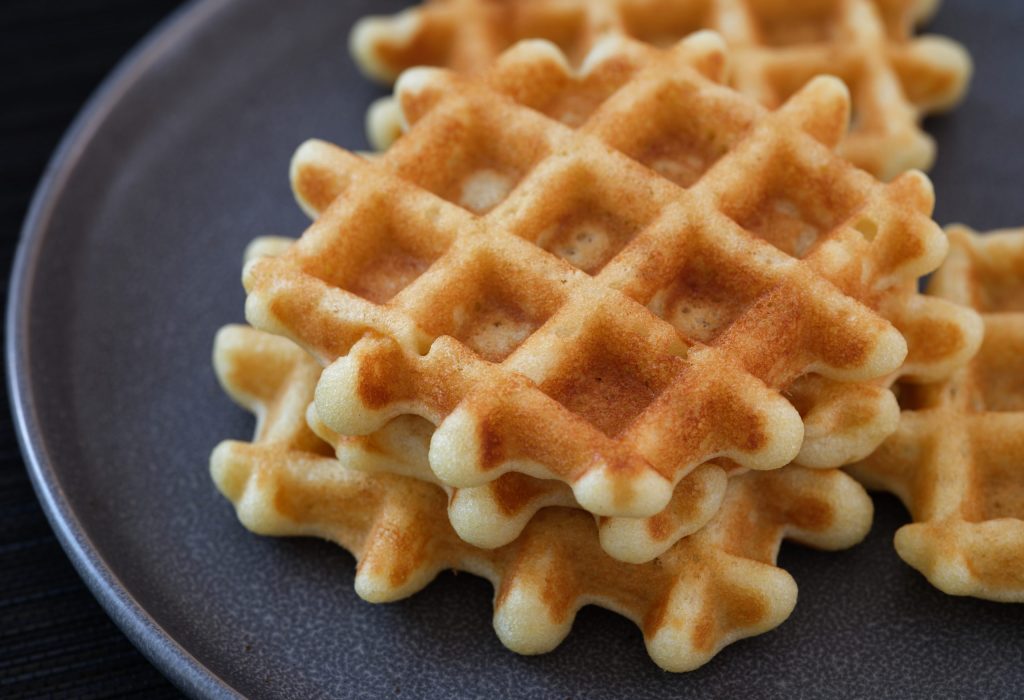 Homemade gluten free waffles on a gray plate Homemade gluten free waffles on a gray plate. Close up.